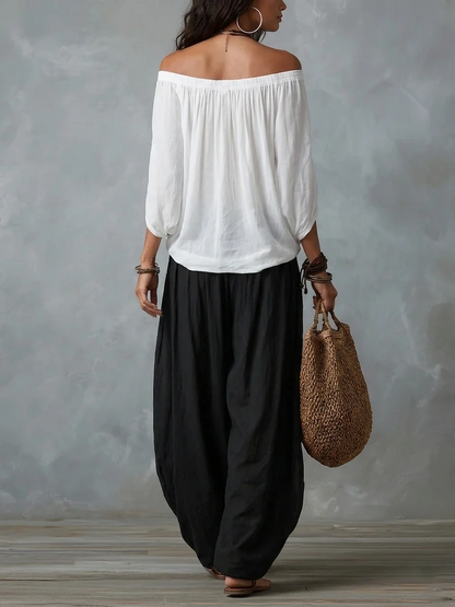 Conjunto Équilibre | Conjunto de top blanco con hombros descubiertos y pantalones holgados tipo farol.